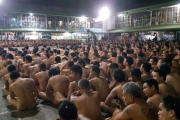 Cientos de presos obligados a desnudarse y sentados en fila en el patio de la cárcel de Cebú.-AFP