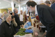 El líder del PP, Mariano Rajoy, charla con una dependienta durante un paseo electoral por Galicia.-EFE/Lavandeira jr