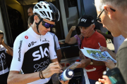 Chris Froome atiende a un aficionado, a las puertas de su hotel en Chambery.-JEAN-PIERRE CLATOT