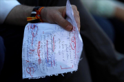 El presidente en funciones y candidato del PP, Mariano Rajoy, repasando unas notas propias antes de intervenir en un mitin en Málaga-JON NAZCA / REUTERS