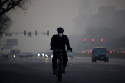 Un ciclista circula por Pekín en un día de alta contaminación.-REUTERS