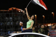 Aficionados sirios celebran el empate ante Irán.-AFP / LOUAI BESHARA