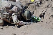 Un soldado iraquí reza ante la tumba de uno de los militares masacrados por el Estado Islámico en el 2014.-REUTERS