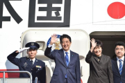 Abe (segundo por la izquierda) y su esposa, Akie, saludan antes de embarcarse en el avión hacia EEUU, en el aeropuerto de Haneda (Tokio), este jueves.-AFP / KAZUHIRO NOGI