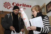 Un hombre recibe alimentos en Cáritas. / FERNANDO SANTIAGO-