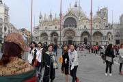 Turistas se hacen fotos frente a la catedral de San Marco, en Venecia, el 20 de octubre.-/ AFP / MIGUEL MEDINA