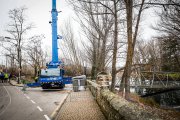 La grúa se posiciona en el paseo del Postiguillo para retirar la pasarela.