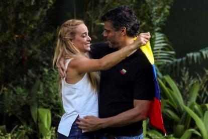 Leopoldo López abraza a su esposa Lilian Tintori en los exteriores de la embajada de España en Caracas.-EFE