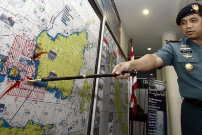 Abdul Rashid, comandante responsable del equipo indonesio de búsqueda, señala la zona de rastreo del avión, este lunes en Batau (Indonesia).-Foto: EFE / MASSULIS MBASAN