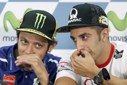 Andrea Iannone, a la derecha, dialoga con Valentino Rossi.-EFE / ANDREU DALMAU