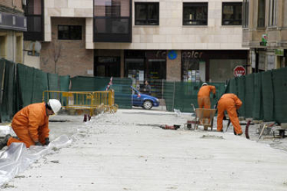 Operarios trabajan en las obras que se están realizando para el mercado provisional en la calle Sagunto de la capital soriana. / ÁLVARO MARTÍNEZ-