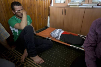 Un palestino, junto al cuerpo de Alí Dawabsheh, el bebé muerto en el incendio.-Foto: AP / MAJDI MOHAMMED