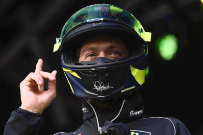 Valentino Rossi se pone su casco antes de subastarlo, en Silverstone, para que todo el mundo vea que es el suyo.-MILAGRO / TINO MARTINO