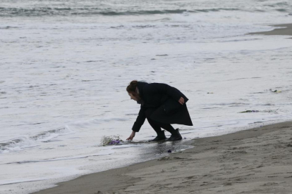 Mark Kanekita, de 37 años, lanza flores al mar en memoria de las víctimas del terremoto y posterior tsunami de hace cinco años en el distrito de Abraham en Sendai (Japón).-KIMIMASA MAYAMA / EFE
