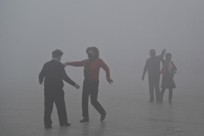 Personas con mascarillas bailan en un parque de Fuyang, el martes 3 de enero.-AP