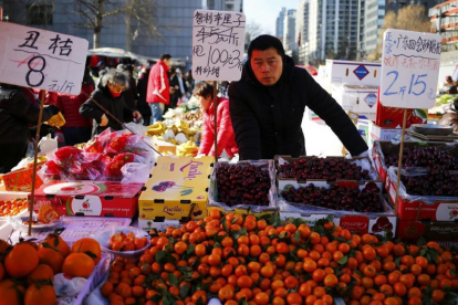 Un vendedor de fruta en un mercado de Pekín.-WU HONG / EFE