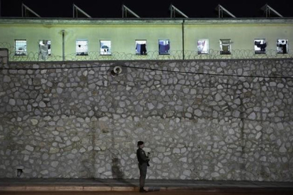 Fotografía de archivo de un agente de policia haciendo guardia frente la cárcel de Korydallos, en Atenas.-AP / PETROS GIANNAKOURIS