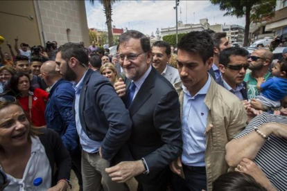El presidente del Gobierno en funciones, Mariano Rajoy, increpado a su llegada al municipio valenciano de Alfafar.-MIGUEL LORENZO