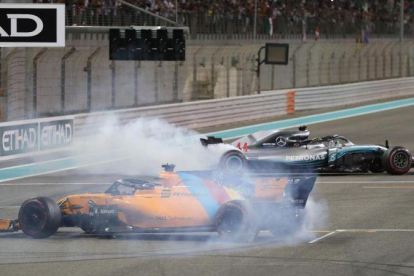 Lewis Hamilton y Fernando Alonso hacen trompos con sus monoplazas al finalizar el GP de Abu Dabi.-REUTERS / AHMED JADALLAH