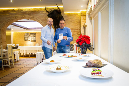 David Santiago y Raúl Lozano con los platos elaborados  por el Fogón del Salvador en Soria.-MARIO TEJEDOR