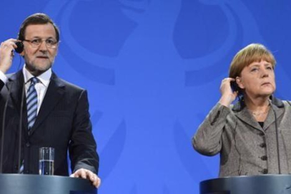 Rajoy y Merkel, en una rueda de prensa en Berlín.-/ PERIODICO (AFP PHOTO / ODD ANDERSEN)