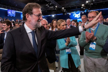 Mariano Rajoy, junto a la presidenta de la Comunidad de Madrid, Cristina Cifuentes, y al presidente del PP vasco, Alfonso Alonso, saluda a los asistentes a la convención, este domingo.-EFE / JULIO MUÑOZ