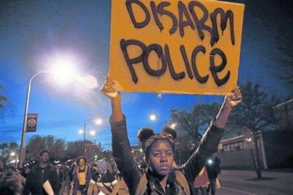 Una manifestante sostiene un cartel en una marcha solidaria con Baltimore, este miércoles en Chicago.-Foto: REUTERS / JIM YOUNG