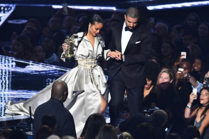 Drake acompaña a Rihanna después de que la cantante recibiera un premio.-AFP / JEWEL SAMAD