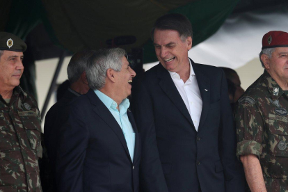 Brazil s President-elect Jair Bolsonaro waves at supporters as he arrives to watch an aerial performance by the private pilots  group a  Esquadrilha do Ceu  or a  Sky Squadron   at Barra beach in Rio de Janeiro  Brazil .-Leo Correa  / AP