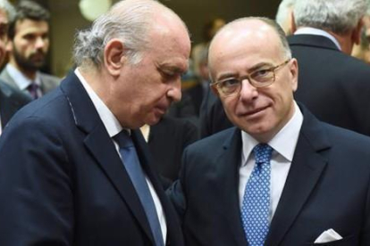 Fernández Díaz (izquierda) conversa con su homólogo francés, Bernard Cazeneuve, este viernes en Bruselas.-AFP / EMMANUEL DUNAND