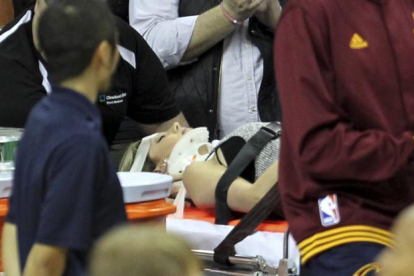 Ellie Day, con collarín, sale en camilla del estadio tras ser arrollada por LeBron James durante una jugada.-AP / JOHN KUNTZ