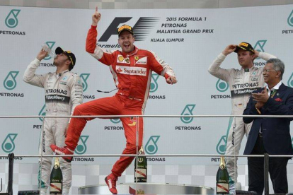 El piloto de Ferrari Sebastain Vettel celebrando su triunfo en el podio de Malasia.-Foto:   MOHD RASFAN / AFP