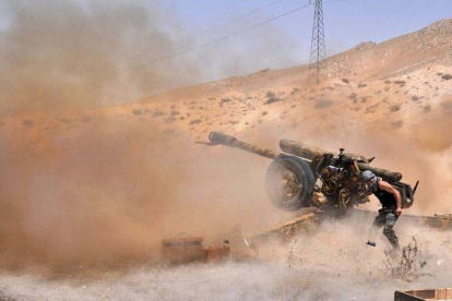 Un soldado del ejército sirio dispara contra el Estado Islámico en el noroeste de Palmira.-Foto: AFP / STR