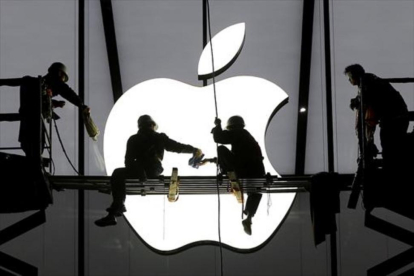 Varios operarios ultiman los trabajos antes de la apertura de una nueva tienda de Apple.-REUTERS / CHANCE CHAN