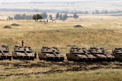 Tanques israelís desplegados este jueves en la frontera que separa los Altos del Golán, territorio ocupado por Israel, y Siria.-AP / MENAHEM KAHANA