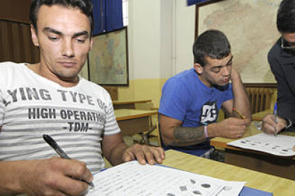Los presos de origen rumano Marcel y Adrian asistieron ayer a su primera clase del curso con el profesor Pepe. / VALENTÍN GUISANDE-