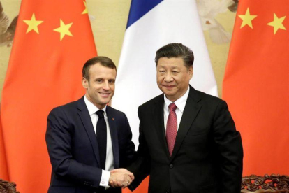 El presidente Xi Jinping y el presindente Emmanuel Macron.-EFE