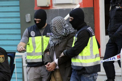 La policía traslada a uno de los detenidos en Ceuta por su presunta relación con las organizaciones terroristas Estado Islámico y Jabhat al Nusra.-EFE