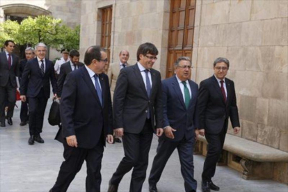 Jordi Jané, Carles Puigdemont, Juan Ignacio Zoido y Enric Millo, en el Pati dels Tarongers de la Generalitat, en julio.-JULIO CARBÓ