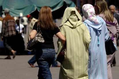 Mujeres vestidas al uso occidental junto a otras con vestimentas tradicionales, en la plaza Jemaa El Fna, en Marraquech, en una imagen de archivo.-XAVIER JUBIERRE