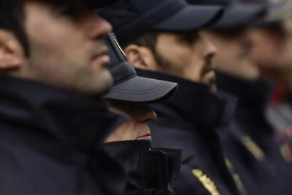 Agentes de la policía guardan un minuto de silencio en memoria de los dos policías asesinados el viernes en Afganistán.-AP / ALVARO BARRIENTOS