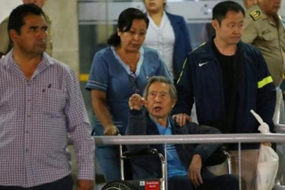 El expresidente peruano Alberto Fujimori saluda a sus simpatizantes junto a su hijo, el congresista Kenji Fujimori, al salir de la Clínica Centenario en Lima.-LUKA GONZALES