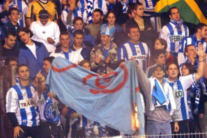 Aficionados del grupo radical Riazor Blues queman una bandera durante un partido, en octubre del 2003.-Foto: ARCHIVO / EFE