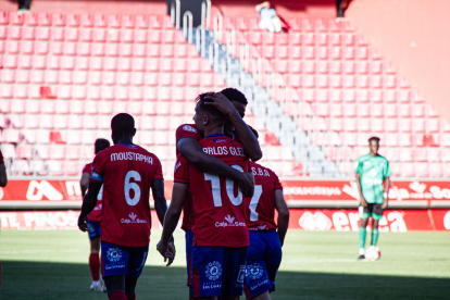 Carlos González, el mejor numantino ante el Atlético Paso, se abraza con Noé.