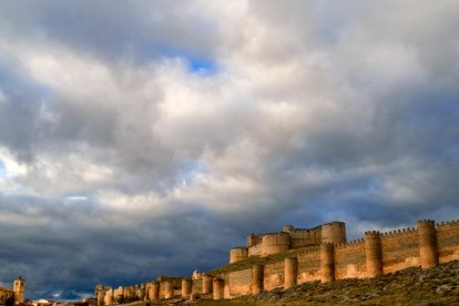 Vista panorámica del castillo de Berlanga de Duero con su doble muralla bajo un cielo dramático al atardecer.