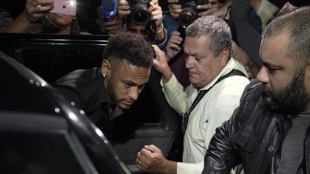 Neymar protegido a la salida de la comisaría de Sao Paulo tras ser interrogado por la policía brasileña por la acusación de violación en junio del 2019.-AP / LEO CORREA