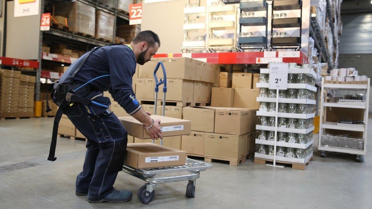 Borja, un empleado de Ikea en Badalona, lleva puesto un exoesqueleto para trabajar con facilidad y corregir errores.-JOSEP GARCÍA (EL PERIÓDICO)