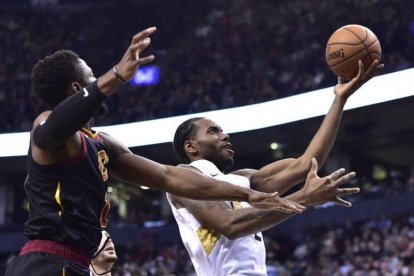 Kawhi Leonard, conducen a la derecha a la canasta, mientras que la escolta de los Cleveland Cavaliers, Rodney Hood, definitivamente a la izquierda durante la segunda mitad del partido de baloncesto de la NBA.-THE CANADIAN PRESS