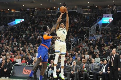 Giannis Antetokounmpo trata de encestar ante la oposición de Bobby Portis.-