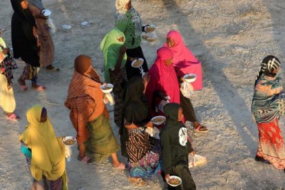 Unos inmigrantes caminan tras recibir comida en un centro de detención en Sabratha, el pasado 9 de octubre.-REUTERS / HANI AMARA